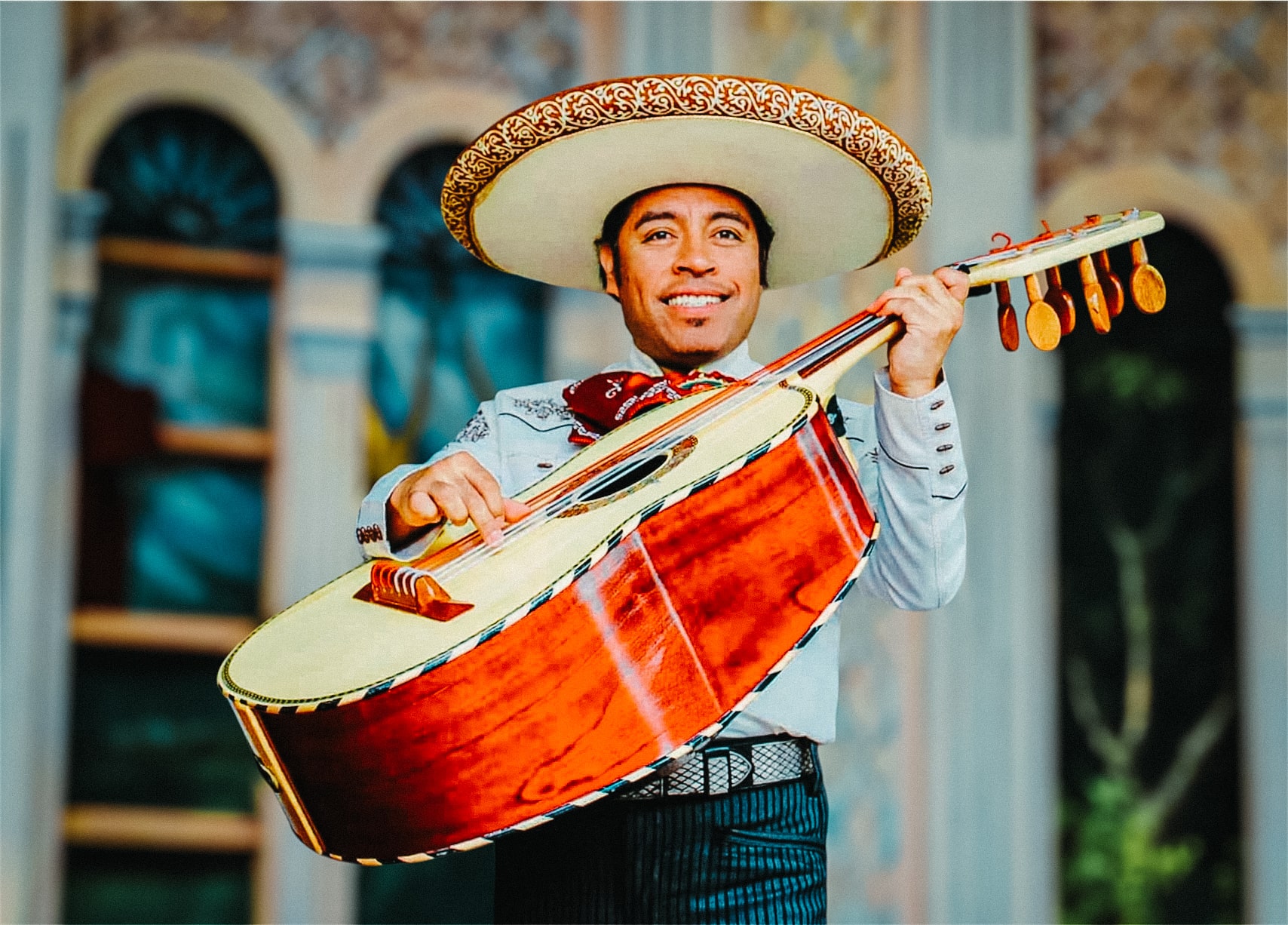 Raul on stage smiling playing his base(Guitarron)